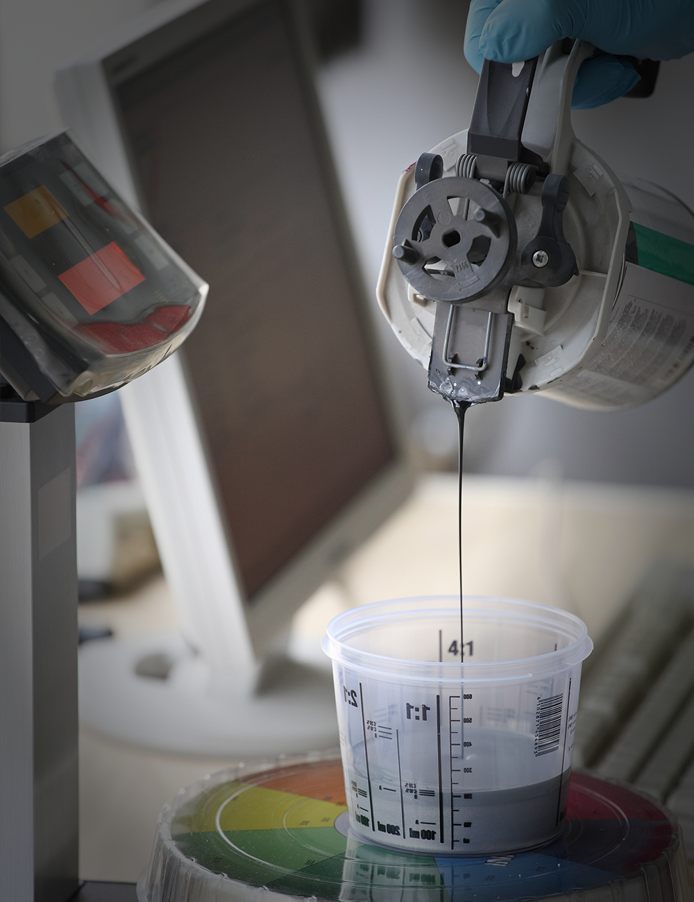 Manual Creative Resins coating process with black material being dispensed into a measuring cup